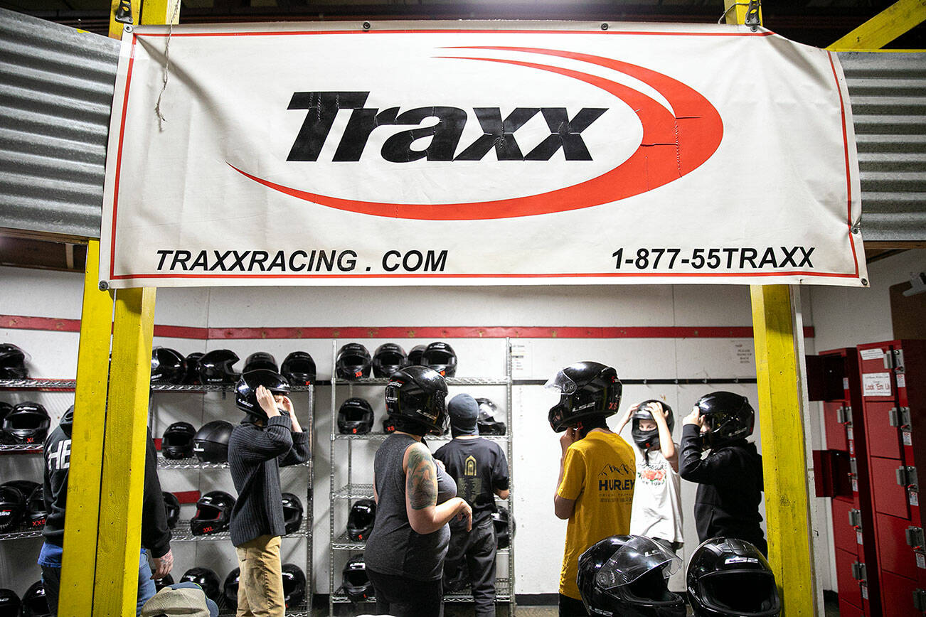 Drivers pick out their helmets before hitting the track at Traxx Indoor Raceway on Friday, Sep. 16, 2022, in Mukilteo, Washington. (Ryan Berry / The Herald)