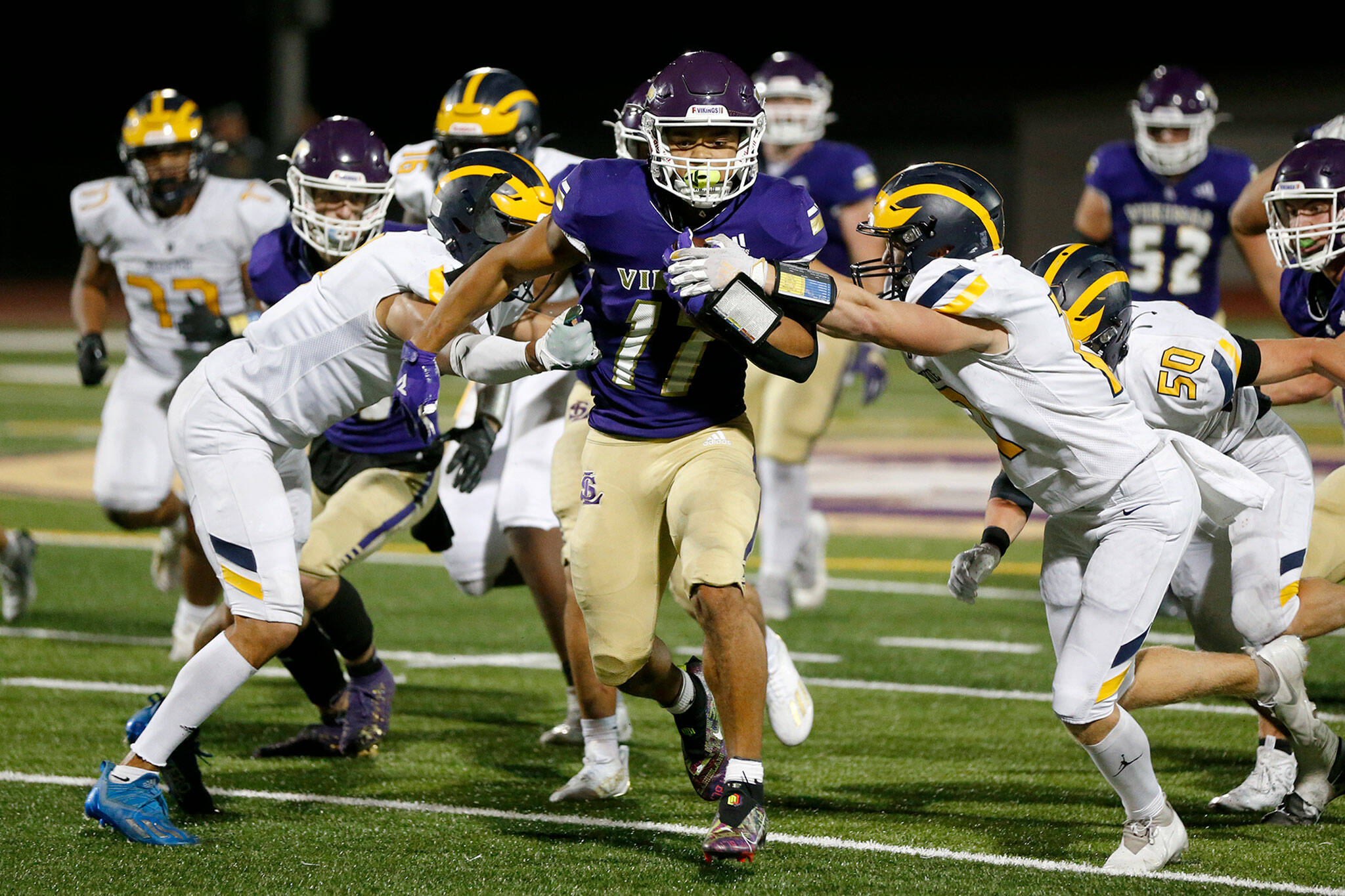 Lake Stevens Jayden Limar muscles through the defense against Bellevue on Friday at Lake Stevens High School. The Vikings claimed the top spot in the first Associated Press state high school football poll of the season. (Ryan Berry / The Herald)