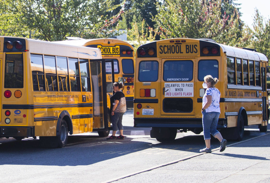 Challenger Elementary School staff chats with bus drivers before school lets out on Monday, in Everett. (Olivia Vanni / The Herald)
