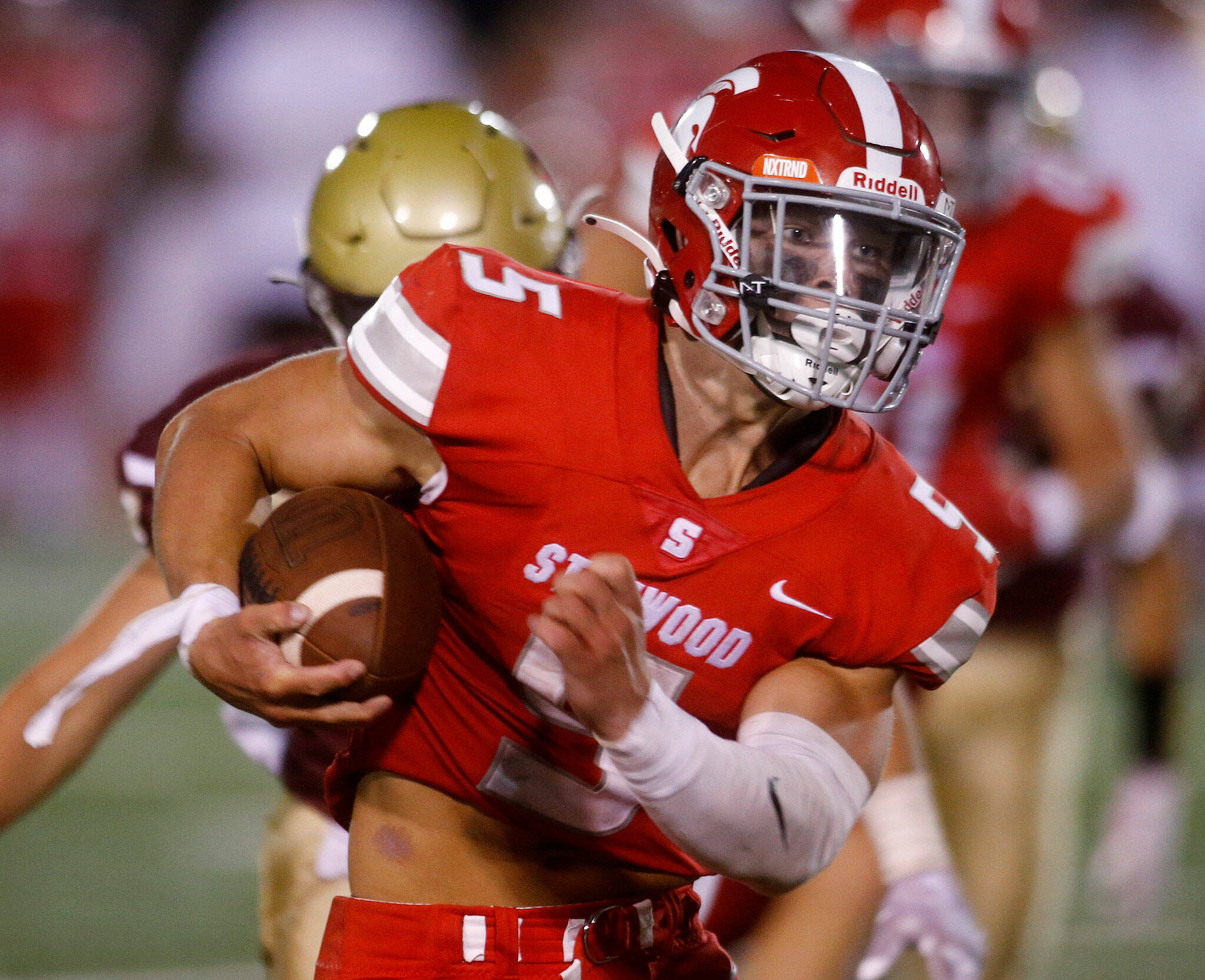 Stanwood’s Ryder Bumgarner takes a carry against Lakewood on Sept. 2 at Lakewood High School in Arlington. Bumgarner leads Snohomish County in rushing yards through two games. (Ryan Berry / The Herald)