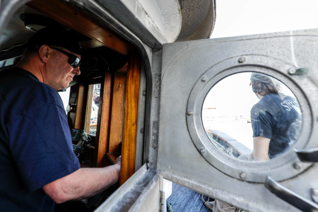 Gary Olsen pilots the St. John II through Fisherman’s Terminal in Seattle on March 31. (Kevin Clark / The Herald)
