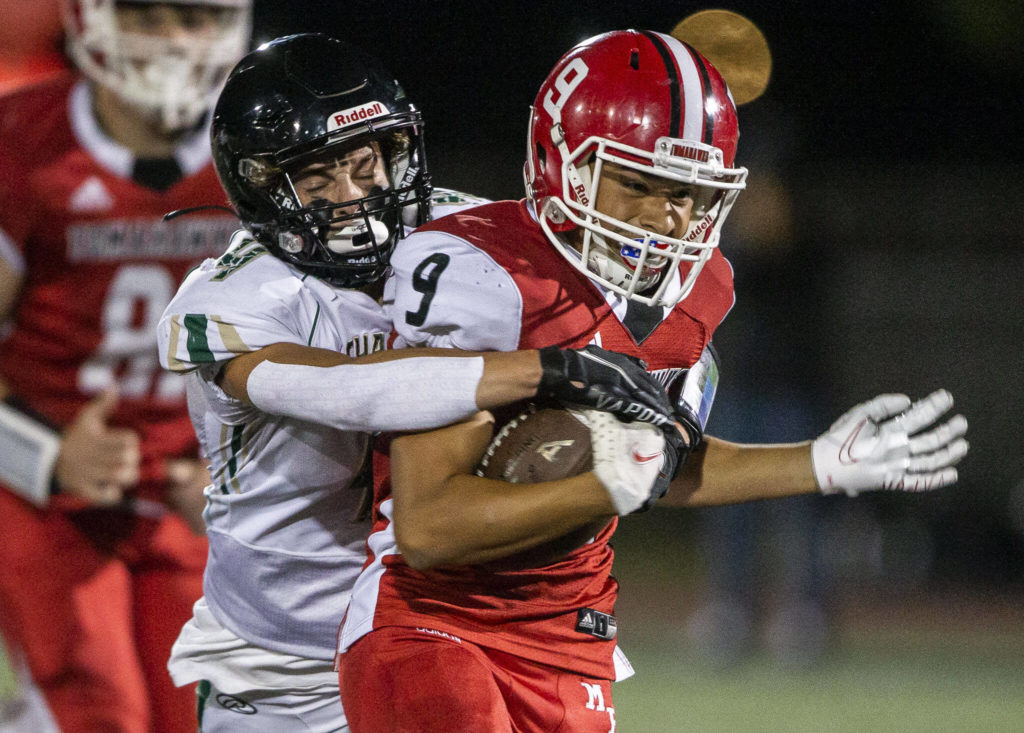 Marysville Pilchuck’s Benito Mejia is tackled by Marysville Getchell’s Eric Davydenko during the game on Friday, Sept. 16, 2022 in Marysville, Washington. (Olivia Vanni / The Herald)
