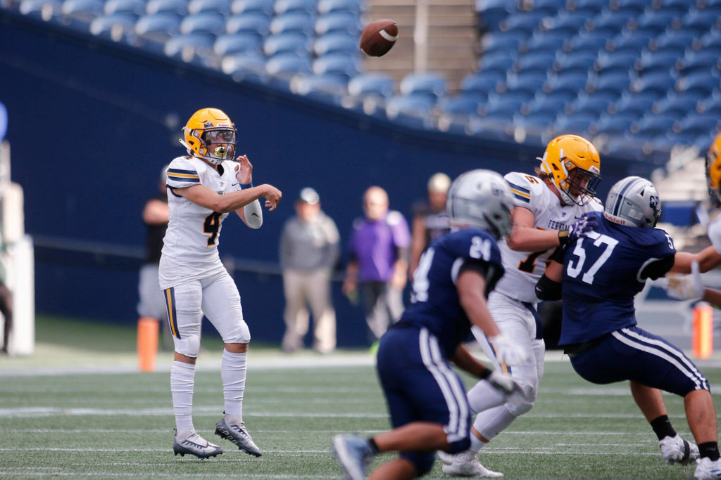 Ferndale’s Bishop Ootsey tosses a short wide receiver screen pass against Glacier Peak on Saturday, Sep. 17, 2022, at Lumen Field in Seattle, Washington. (Ryan Berry / The Herald)

