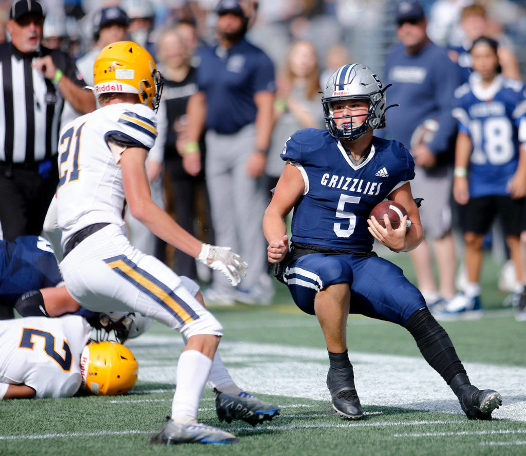 Glacier Peak’s River Lein tries to evade a defender on a long quarterback keeper against Ferndale on Saturday, Sep. 17, 2022, at Lumen Field in Seattle, Washington. (Ryan Berry / The Herald)
