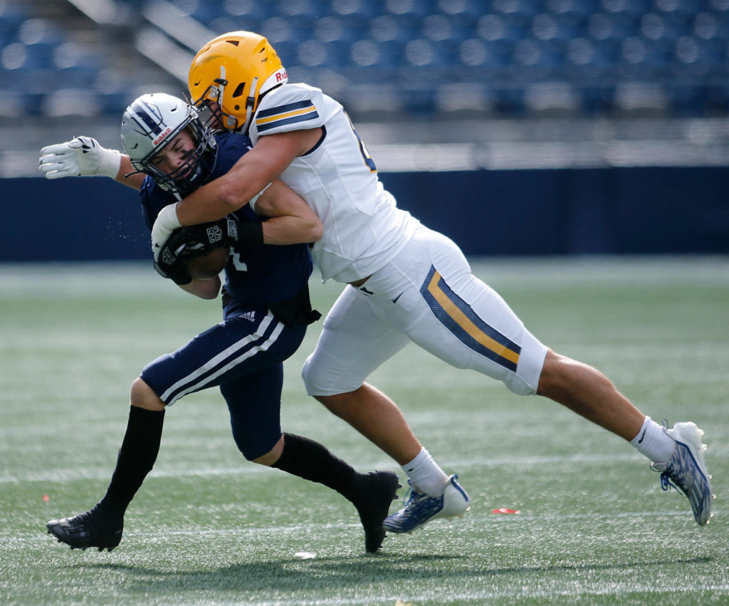 Glacier Peak’s Gabe Russel gets taken down in the open field by Ferndale’s Jake Mason on Saturday, Sep. 17, 2022, at Lumen Field in Seattle, Washington. (Ryan Berry / The Herald)

