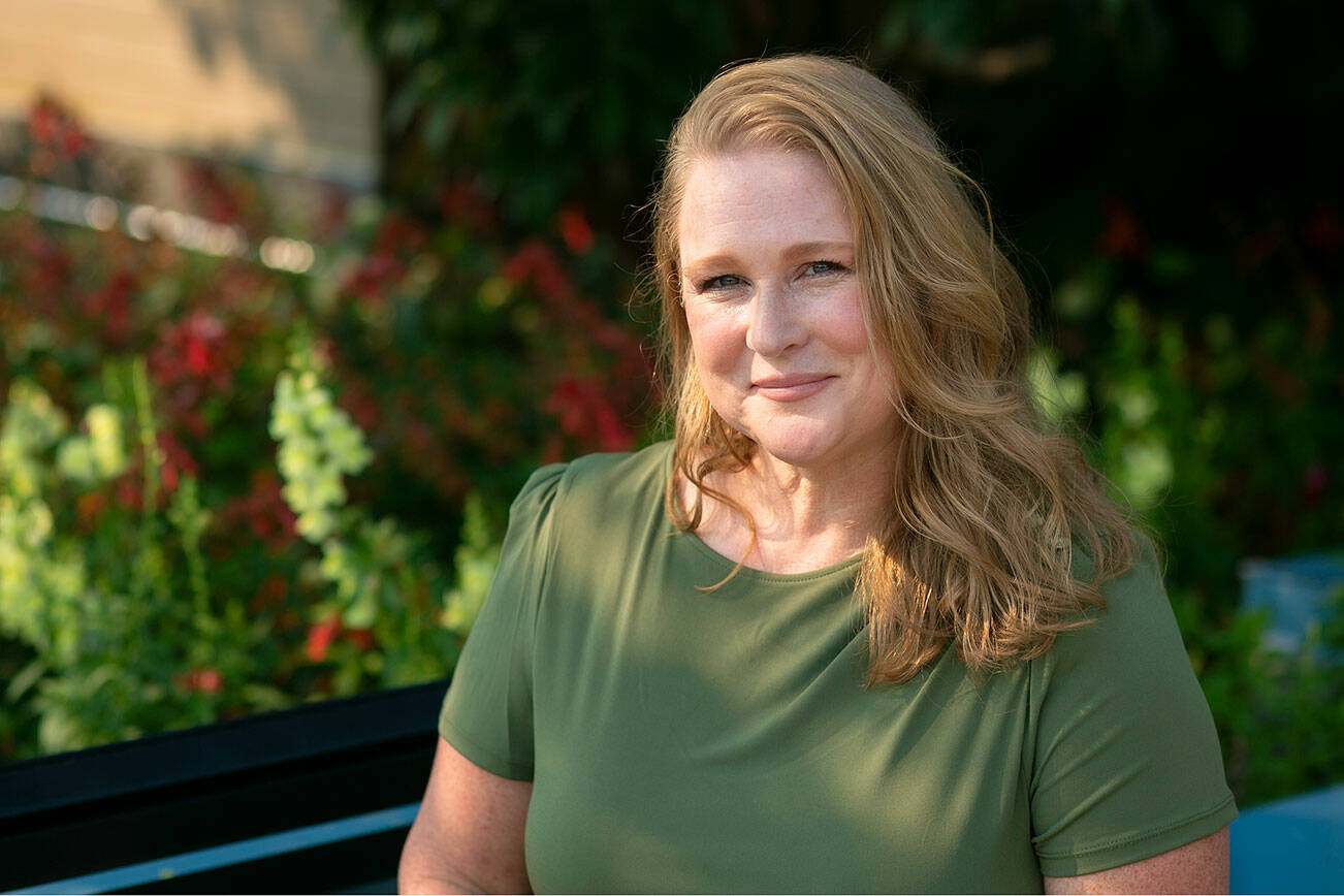 Outgoing Edmonds councilperson Laura Johnson sits in the shade at the park above Edmonds Library on Friday, Sep. 9, 2022, in downtown Edmonds, Washington. (Ryan Berry / The Herald)