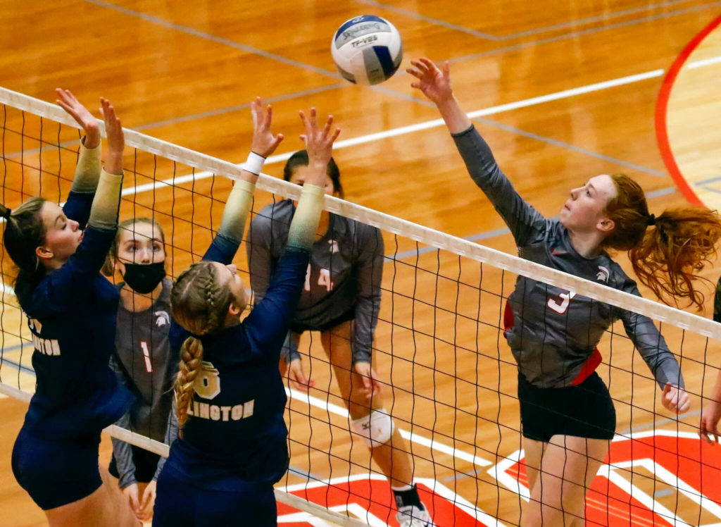Stanwood’s Barrett Anderson goes up for a spike during a match on Oct. 21, 2021, at Stanwood High School. (Kevin Clark / The Herald)
