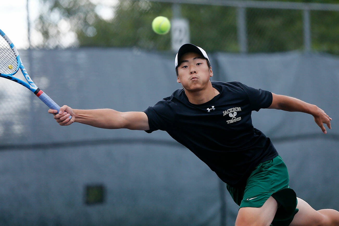 Jackson High’s Ben Lee lunges to get to the ball against Kamiak on Thursday, Sep. 22, 2022, at the Kamiak Tennis Courts in Mukilteo, Washington. (Ryan Berry / The Herald)