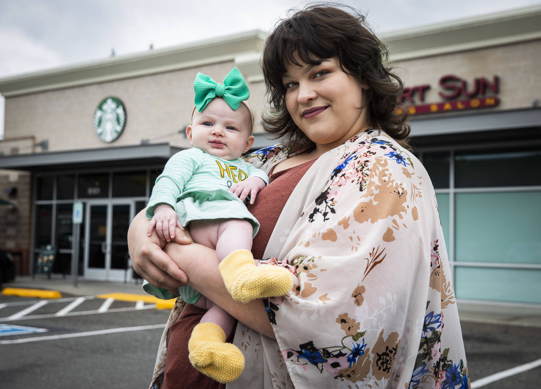 Amber Weaver, who has worked at the Lakewood Crossing Starbucks for 5 years, with her daughter Melody, outside of her workplace on Thursday, Sept. 22, 2022 in Marysville, Washington. (Olivia Vanni / The Herald)