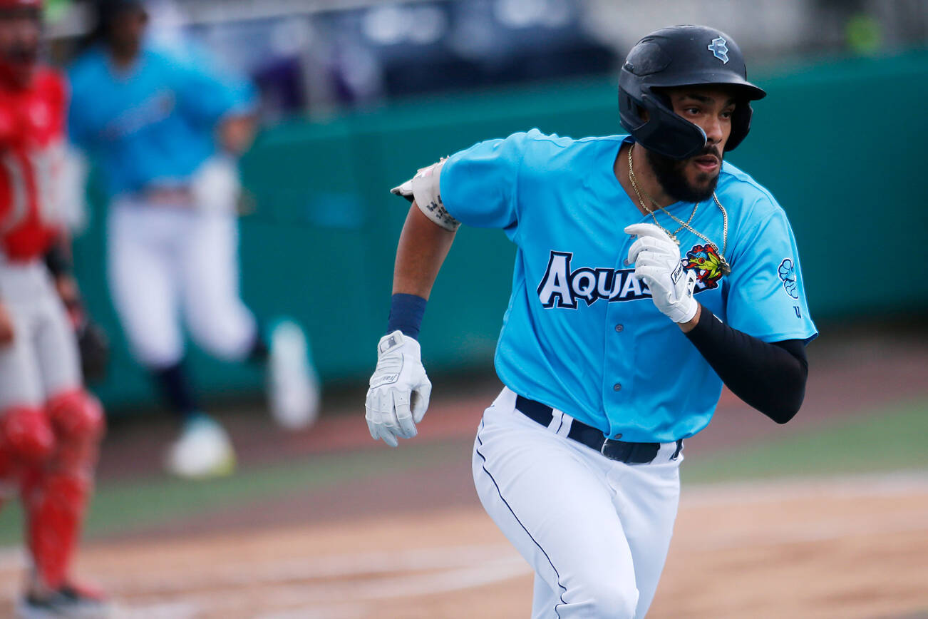 The AquaSox’s Dariel Gomez heads around first after hitting a double to score two runs during a game against the Vancouver Canadians Wednesday, July 6, 2022, at Funko Field in Everett, Washington. (Ryan Berry / The Herald)