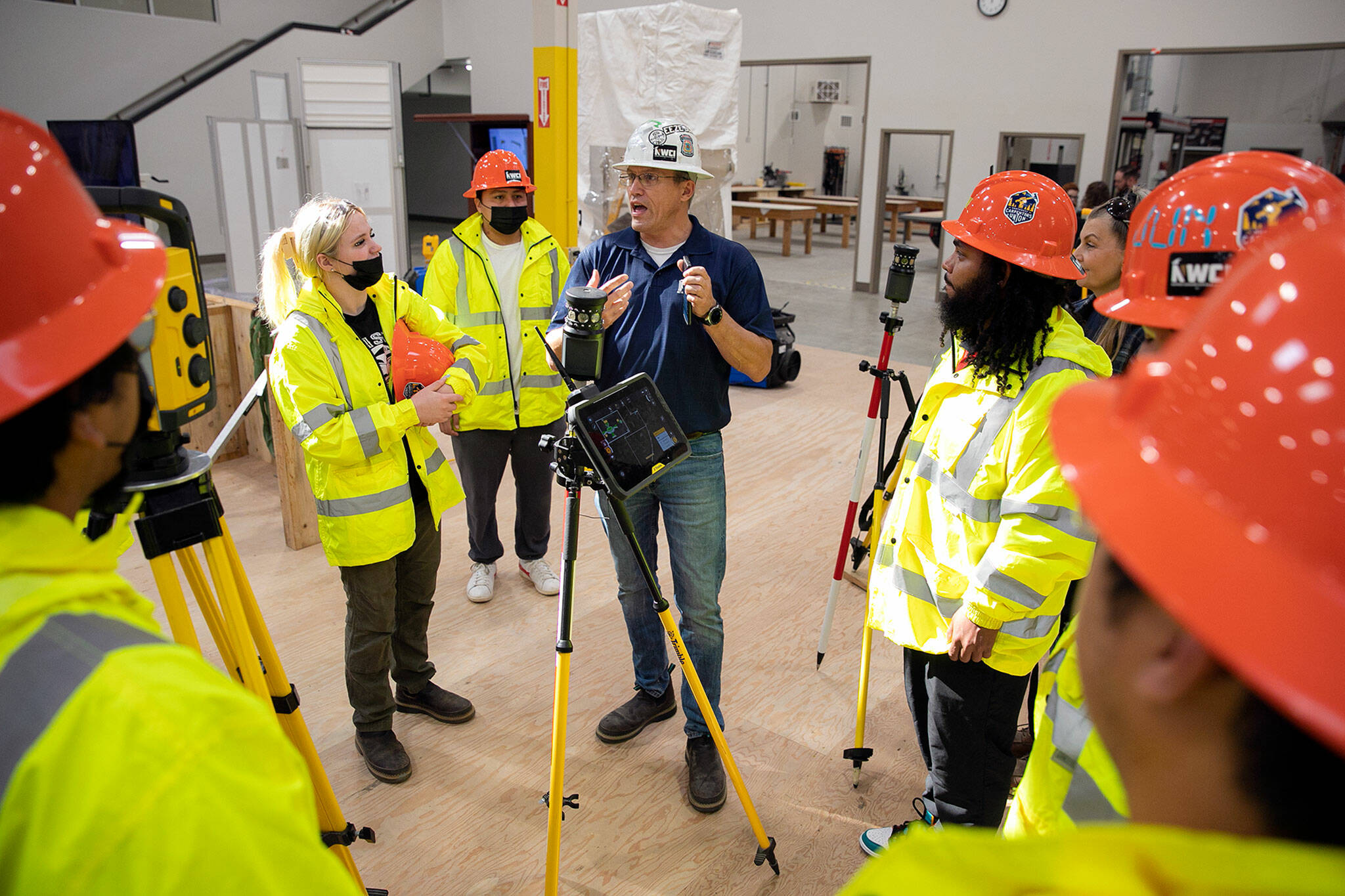 Carpentry instructor Eric Torset speaks with a group of prospective students from TERO Vocational Training Center in Tulalip during the grand opening of the Northwest Carpenters Institute’s new building on Thursday, in Burlington. (Ryan Berry / The Herald)