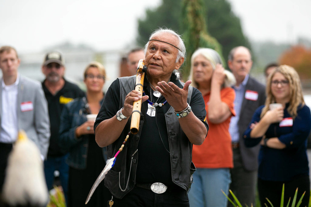 George Montero, Tlingit name Tya-Noche, offers a blessing art the beginning of the grand opening of the Northwest Carpenters Institute’s new building on Thursday, in Burlington. (Ryan Berry / The Herald)
