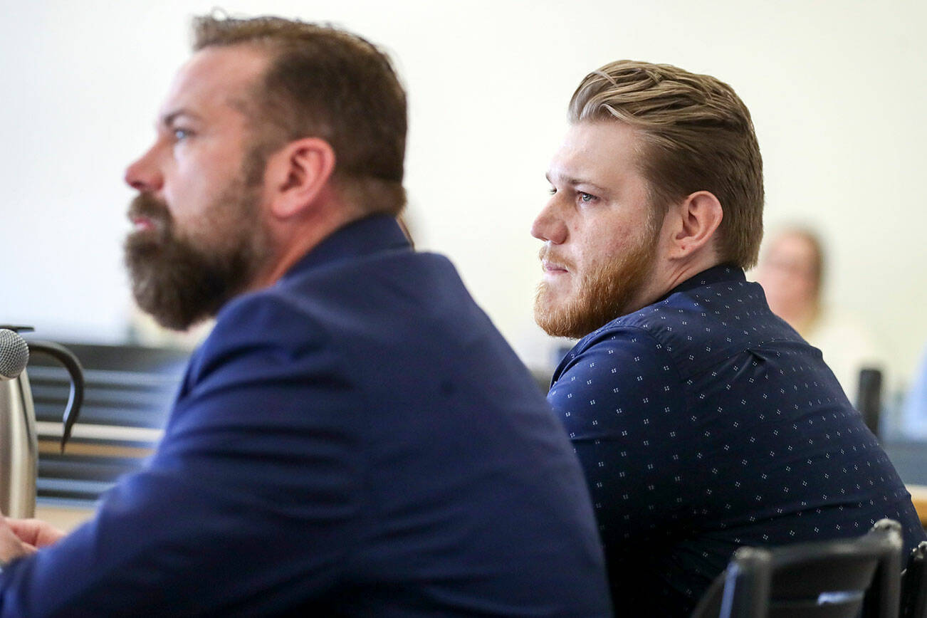 Attorney Michael Andrews, left, and Kyle Brown listen to the judge's address Wednesday afternoon at the Snohomish County Superior Courthouse in Everett, Washington on September 21, 2022. (Kevin Clark / The Herald)