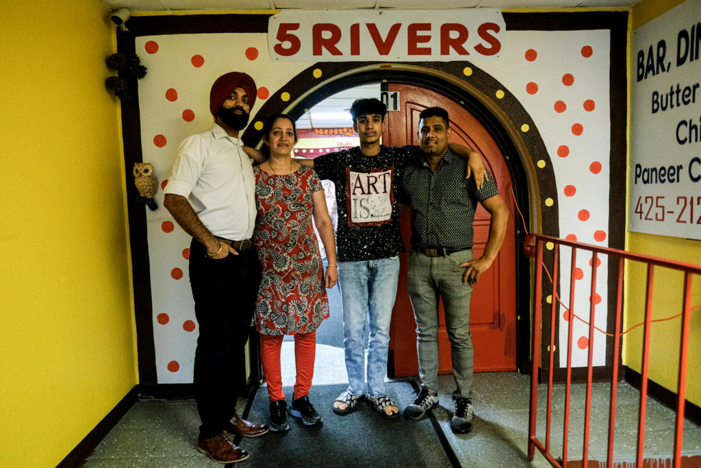 The Kaur family stands in front of their Everett restaurant, 5 Rivers Indian Cuisine on Sept. 21. From left to right: Bhupinder Singh, Baljit Kaur, Lovepreet Singh and Swaran Singh. (Taylor Goebel / The Herald)
