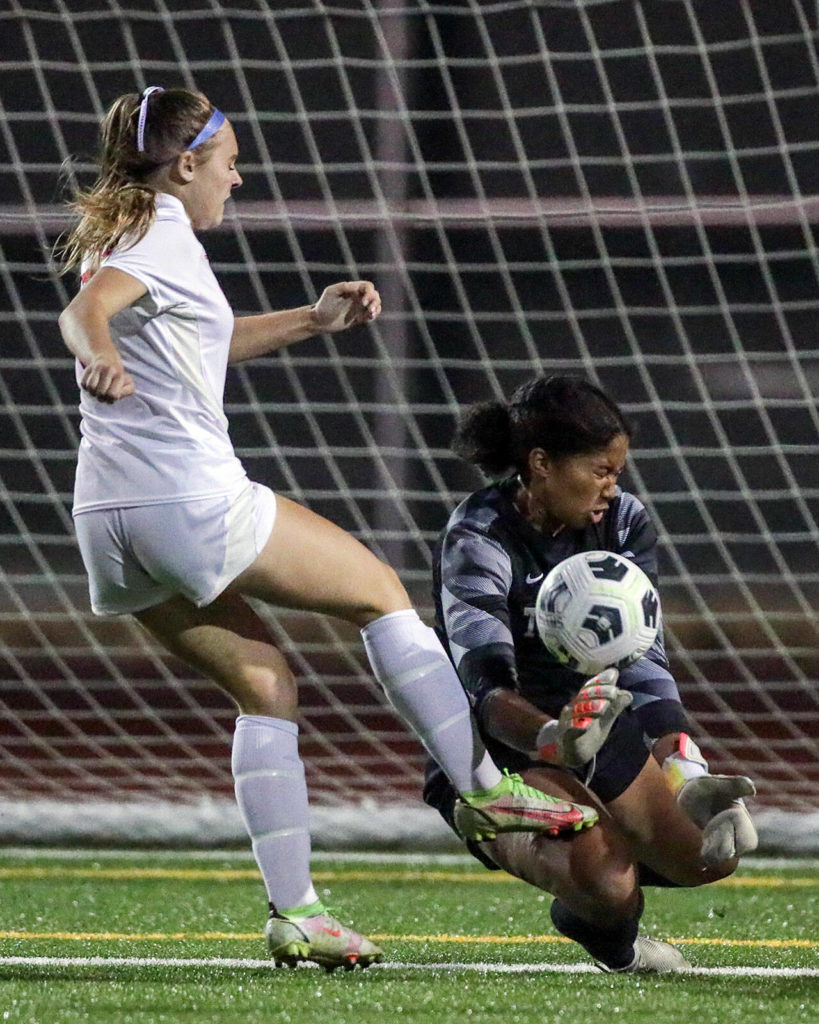 Mountlake Terrace’s Sierra Sonko gathers a shot at goal with Archbishop Murphy’s Bella Urbaniak closing Thursday night at Lynnwood High School in Lynnwood, Washington on September 22, 2022. The Hawks and Wildcats finished the match with 1-1 tie. (Kevin Clark / The Herald)
