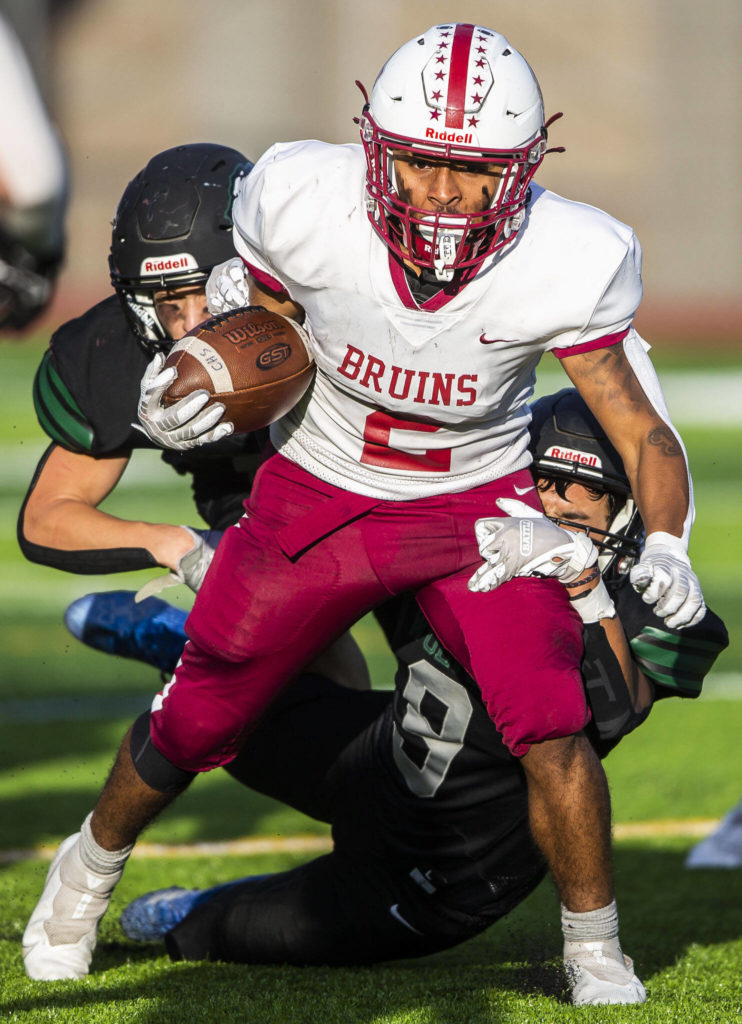 Cascade’s Julian Thomas runs through a tackle during the game against Jackson on Friday, Sept. 23, 2022 in Everett, Washington. (Olivia Vanni / The Herald)
