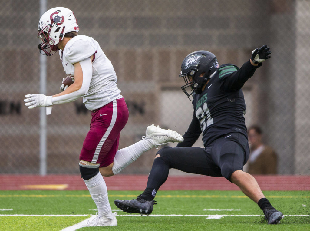 Cascade’s Charlie Nelson throws off a tackle to run the ball in for a touchdown during the game against Jackson on Friday, Sept. 23, 2022 in Everett, Washington. (Olivia Vanni / The Herald)
