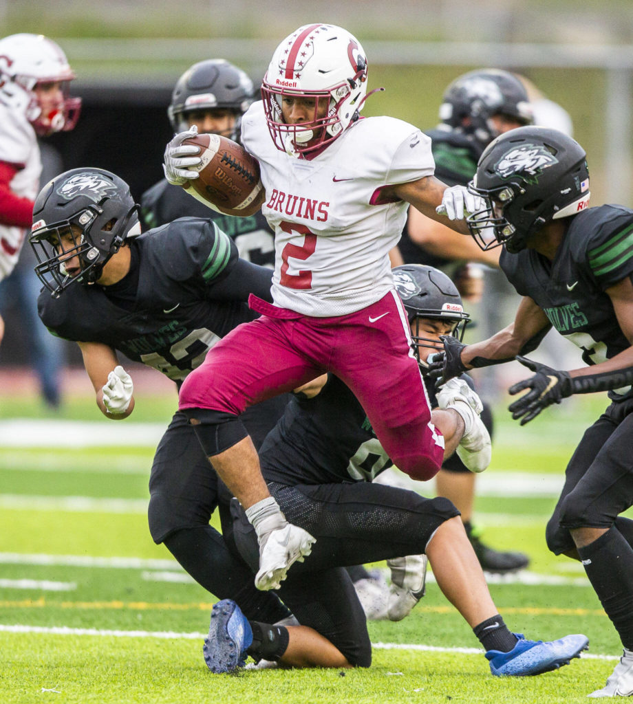 Cascade’s Julian Thomas jumps over multiple tackles during the game against Jackson on Friday, Sept. 23, 2022 in Everett, Washington. (Olivia Vanni / The Herald)
