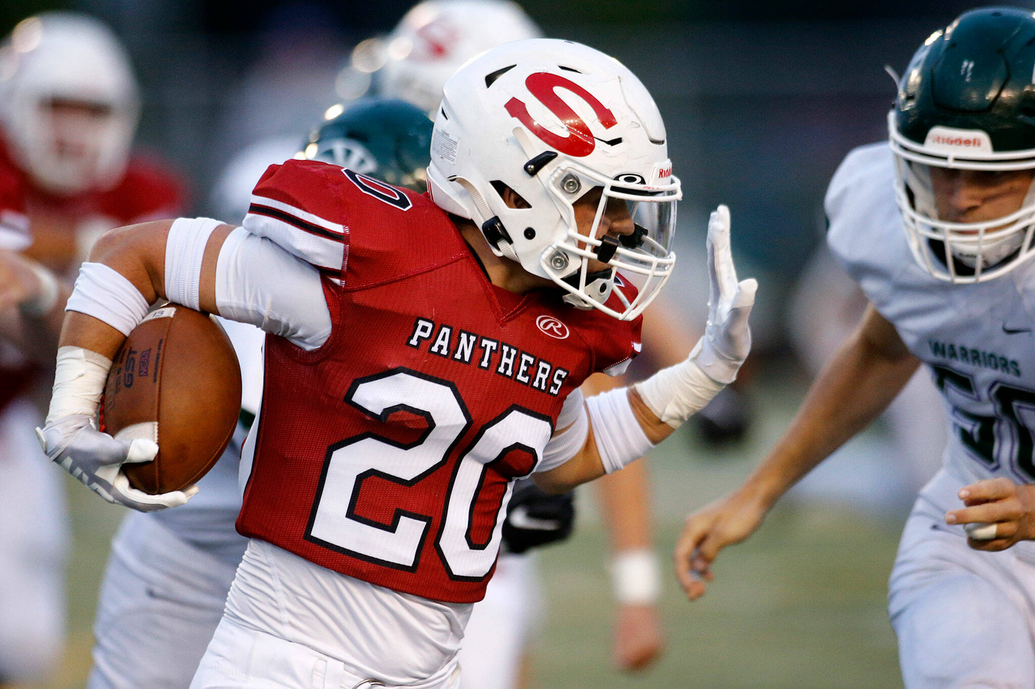 Snohomish’s Mason Orgill prepares to stiff-arm a defender on a big run against Edmonds-Woodway on Friday, Sep. 23, 2022, at Snohomish High School in Snohomish, Washington. (Ryan Berry / The Herald)