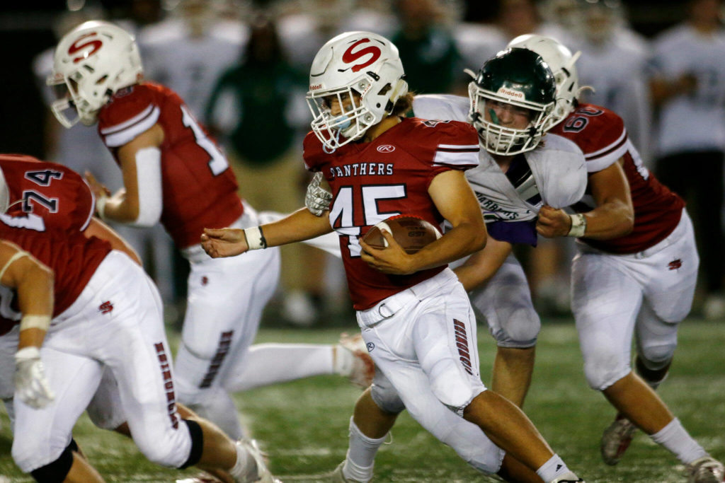 Snohomish’s Caleb Podoll sheds a tackle on a run against Edmonds-Woodway on Friday, Sep. 23, 2022, at Snohomish High School in Snohomish, Washington. (Ryan Berry / The Herald)
