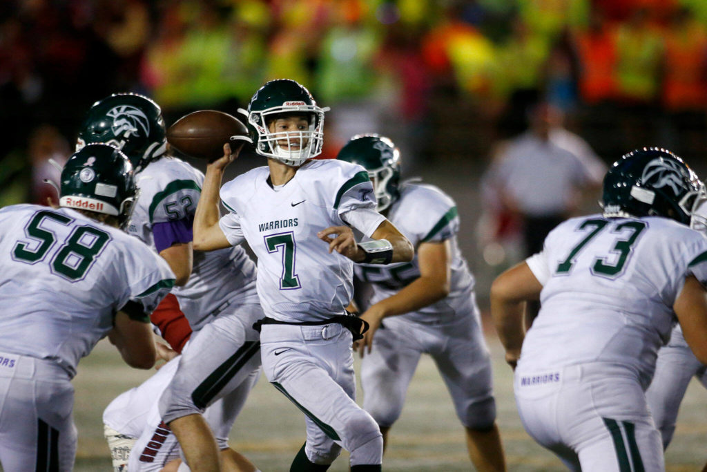 Edmonds-Woodway’s Steven Warren Jr. steps up in the pocket to make a pass against Snohomish on Friday, Sep. 23, 2022, at Snohomish High School in Snohomish, Washington. (Ryan Berry / The Herald)
