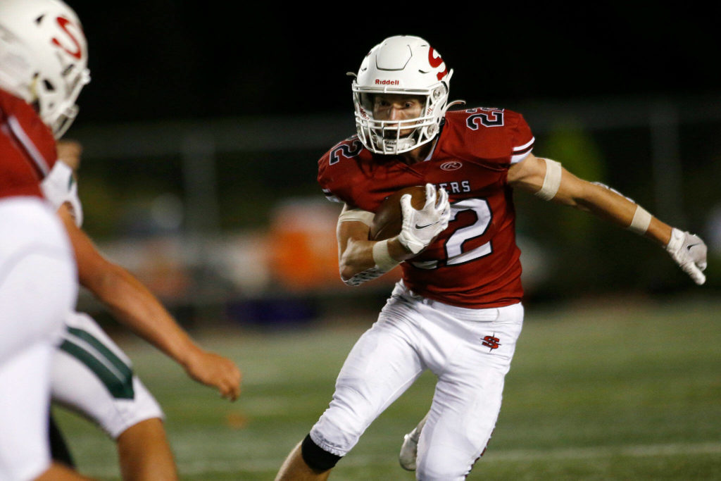 Snohomish’s Kyle Larson finds space up the middle on a run against Edmonds-Woodway on Friday, Sep. 23, 2022, at Snohomish High School in Snohomish, Washington. (Ryan Berry / The Herald)
