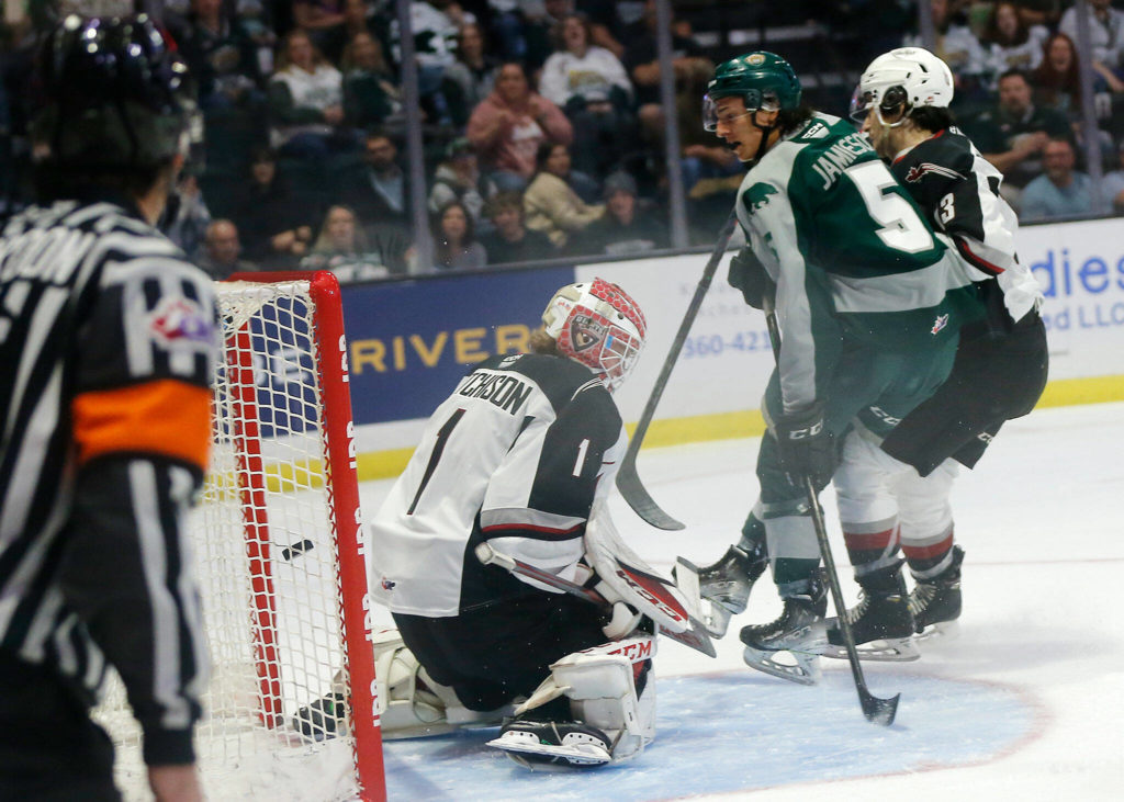 Everett Silvertips’ Eric Jamieson sneaks the puck into the net to put his team up 2-0 during the season opener against the Vancouver Giants on Saturday, Sep. 24, 2022, at Angel of the Winds Arena in Everett, Washington. (Ryan Berry / The Herald)