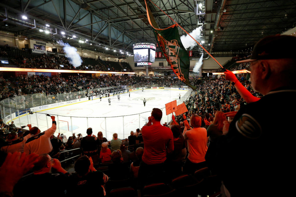 Fans celebrate the Everett Silvertips’ first goal of the year during the season opener against the Vancouver Giants on Saturday, Sep. 24, 2022, at Angel of the Winds Arena in Everett, Washington. (Ryan Berry / The Herald)