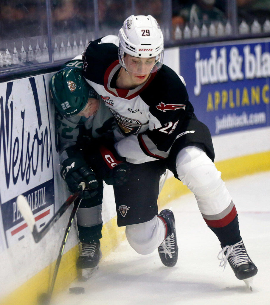 Everett Silvertips’ Jesse Heslop gets slammed into the boards during the season opener against the Vancouver Giants on Saturday, Sep. 24, 2022, at Angel of the Winds Arena in Everett, Washington. (Ryan Berry / The Herald)