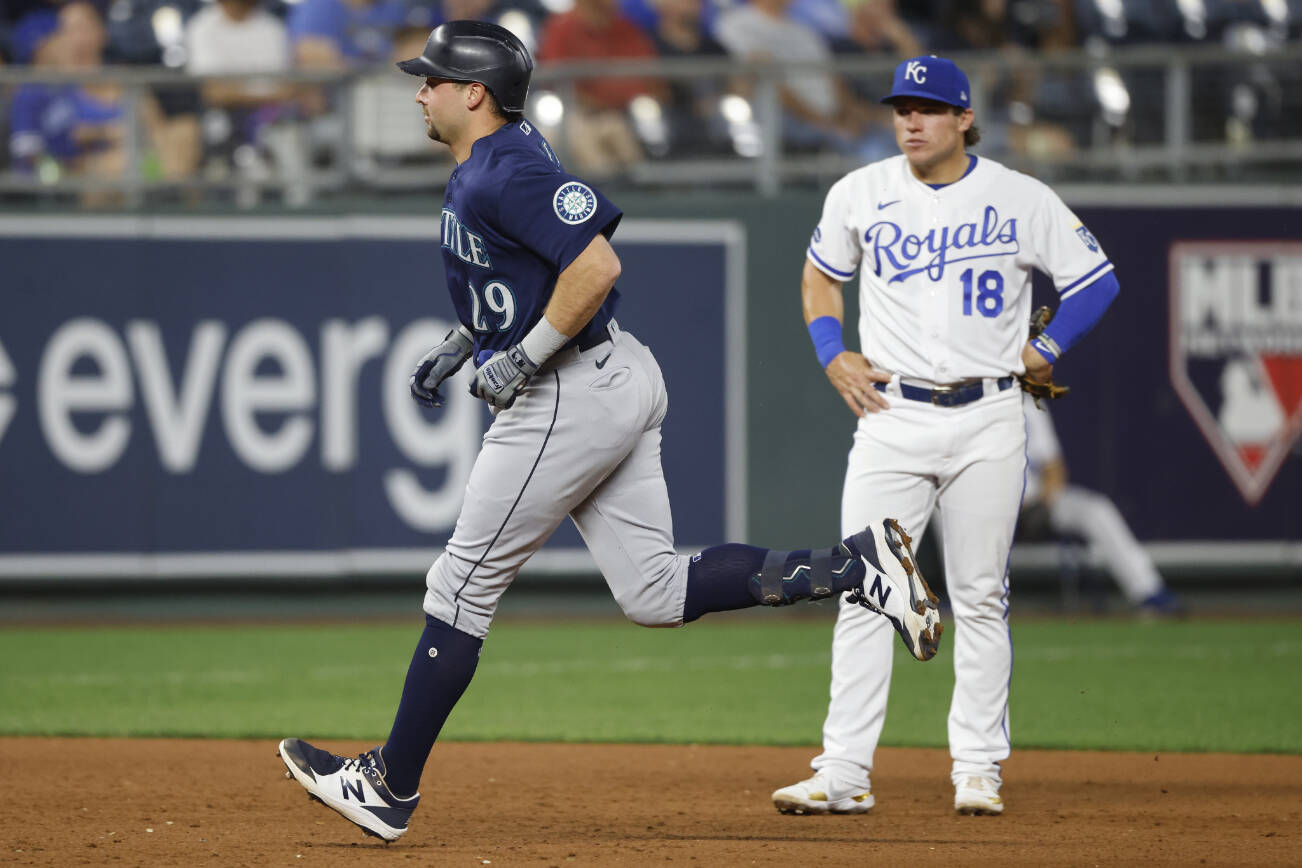 Seattle Mariners' Cal Raleigh (29) runs past Kansas City Royals third baseman Nate Eaton after hitting a two-run home run during the sixth inning of a baseball game in Kansas City, Mo., Saturday, Sept. 24, 2022. (AP Photo/Colin E. Braley)