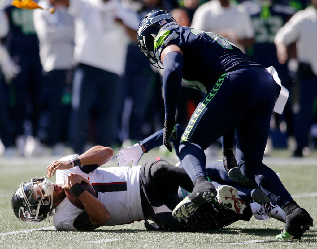 The Atlanta Falcons’ Marcus Mariota gets taken down for a sack against the Seattle Seahawks on Sunday, Sep. 25, 2022, at Lumen Field in Seattle, Washington. (Ryan Berry / The Herald)
