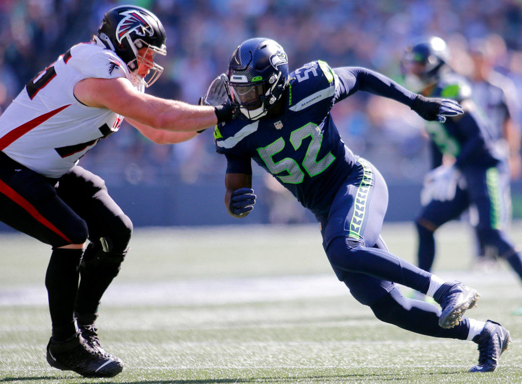 The Seattle Seahawks’ Darrell Taylor tries to beat a lineman around the edge against the Atlanta Falcons on Sunday, Sep. 25, 2022, at Lumen Field in Seattle, Washington. (Ryan Berry / The Herald)
