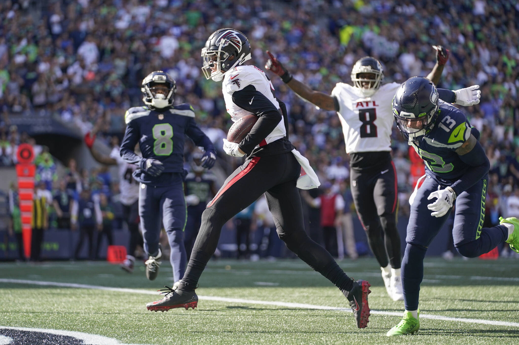 Atlanta Falcons wide receiver Drake London, center, scores a touchdown during the second half of their 27-23 victory over the Seattle Seahawks on Sunday at Lumen Field. (AP Photo/Ashley Landis)