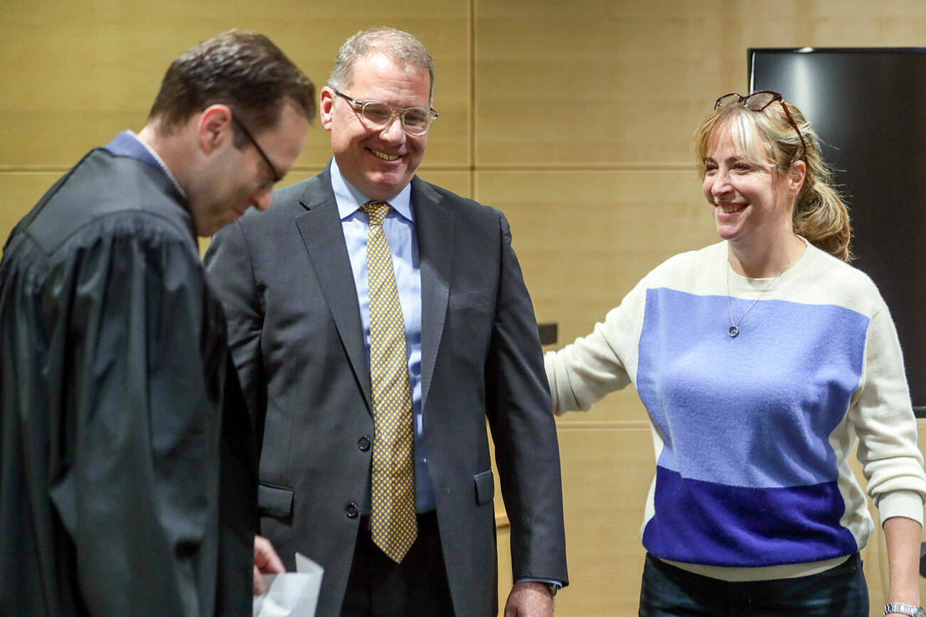 Judge Paul Thompson, left, with Strom Peterson and his wife Maria Montalvo after being is sworn in Wednesday afternoon at the Snohomish County Administration Building in Everett, Washington on September 29, 2022.  (Kevin Clark / The Herald)