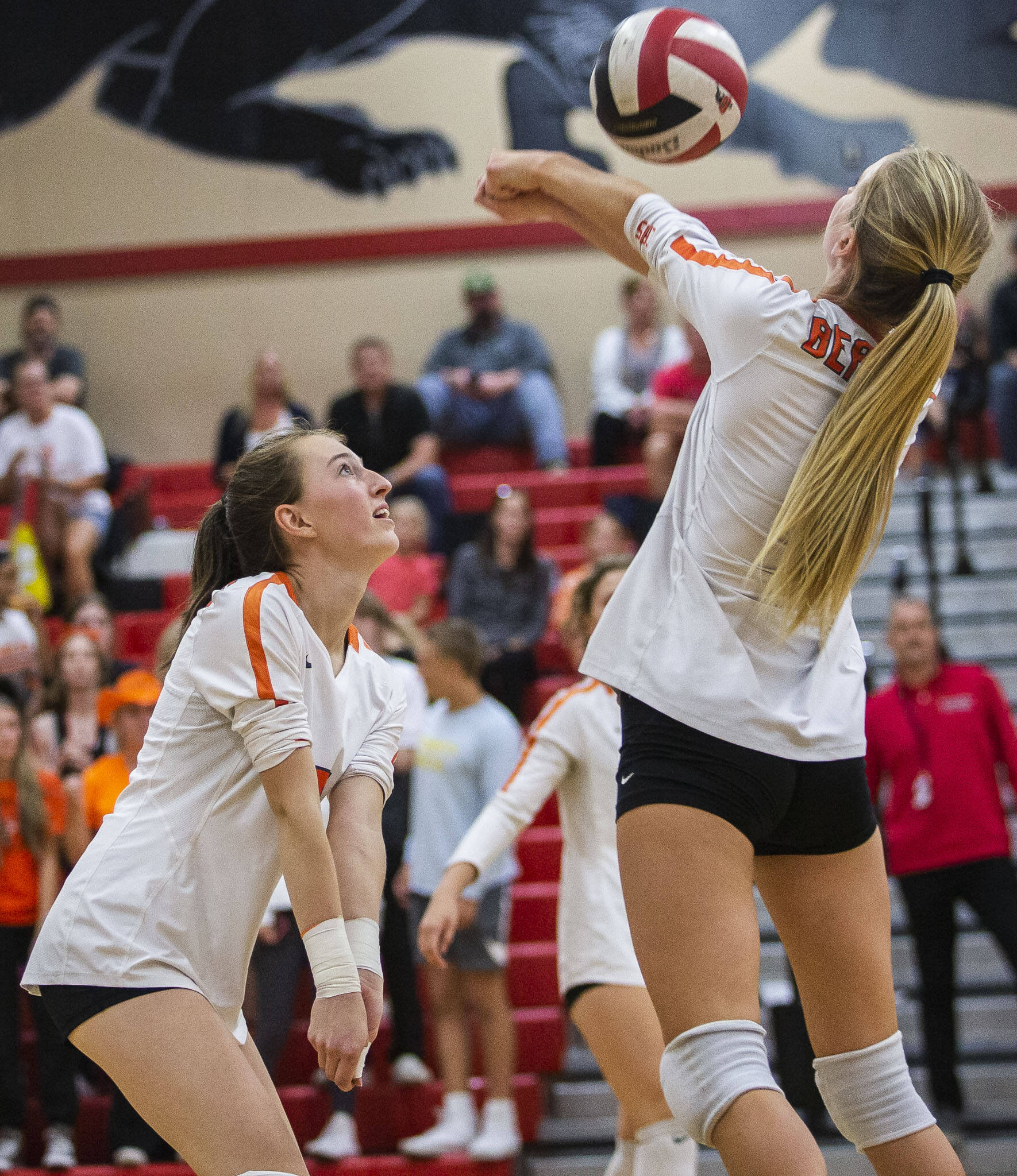 Monroe’s Sara Skold reaches over a teammate to bump the ball during the match against Snohomish on Tuesday, Sept. 27, 2022 in Snohomish, Washington. (Olivia Vanni / The Herald)