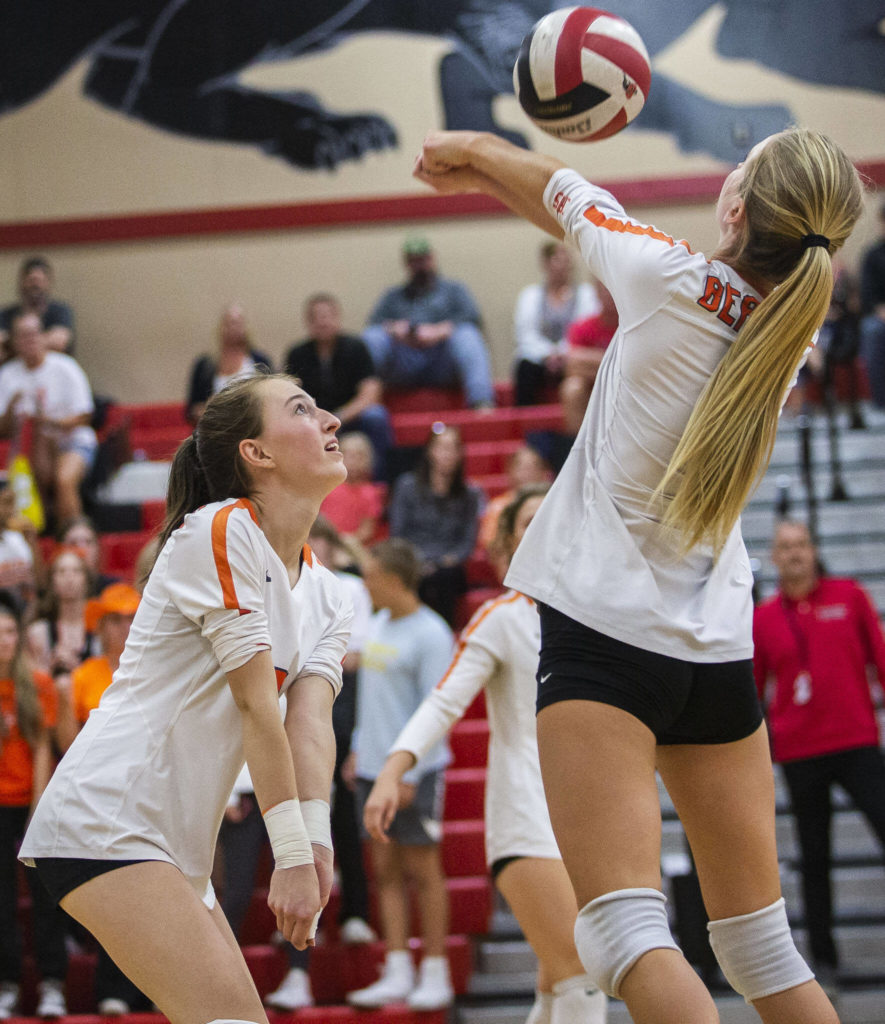 Monroe’s Sara Skold reaches over a teammate to bump the ball during the match against Snohomish on Tuesday, Sept. 27, 2022 in Snohomish, Washington. (Olivia Vanni / The Herald)
