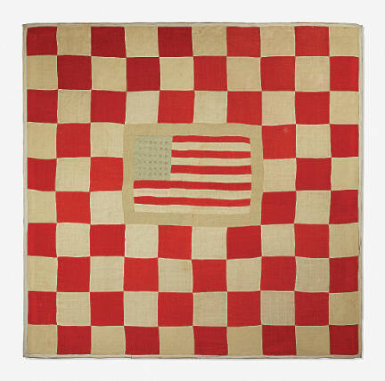 This quilt features an American flag with 36 stars, indicating that it was made about 1865. Most antique quilts are harder to date.