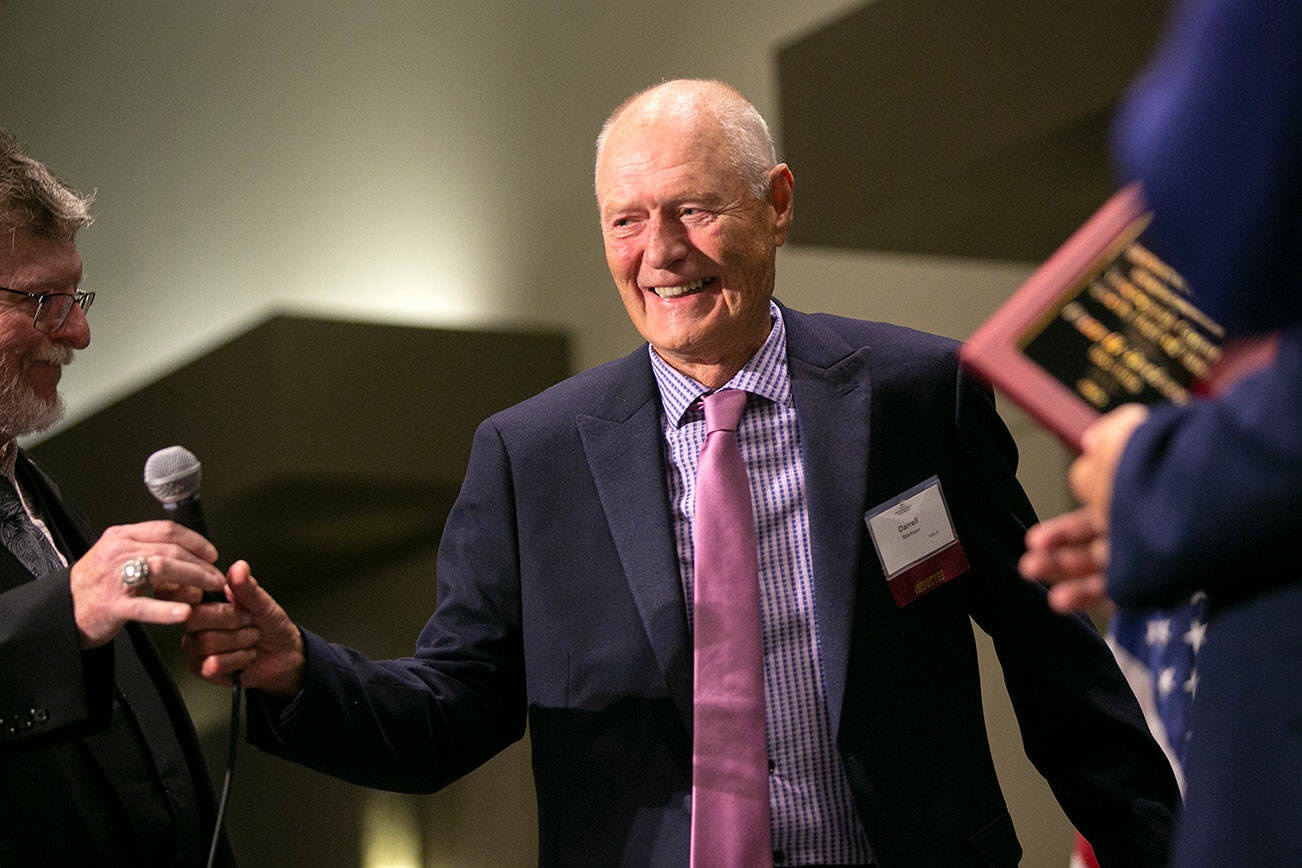 Retired professional bowler Darrell Storkson beams as he walks on stage to accept his Hall of Fame induction during the 2022 Snohomish County Sports Hall of Fame banquet Wednesday, Sep. 28, 2022, at the Edward D. Hansen Conference Center in Everett, Washington. (Ryan Berry / The Herald)