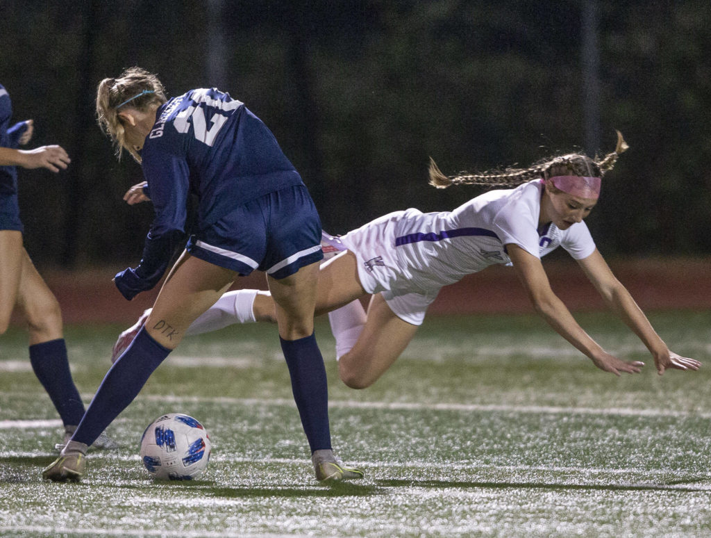 Kamiak’s Britney Nelson-Beier is knocked to the ground by Glacier Peak’s Ryann Reynolds during the game on Thursday, Sept. 29, 2022 in Snohomish, Washington. (Olivia Vanni / The Herald)
