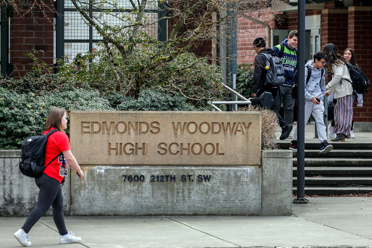 Students make their way after school at Edmonds-Woodway High School on March 12, 2020. All public and private schools in Snohomish, King and Pierce counties must close for six weeks. (Kevin Clark / The Herald)