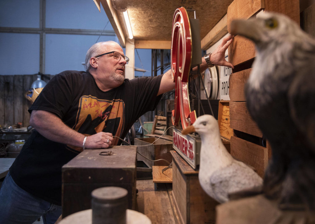 Bryan McClimans adjusts a display inside his store Second Chance Antiques on Thursday, in Everett. (Olivia Vanni / The Herald)
