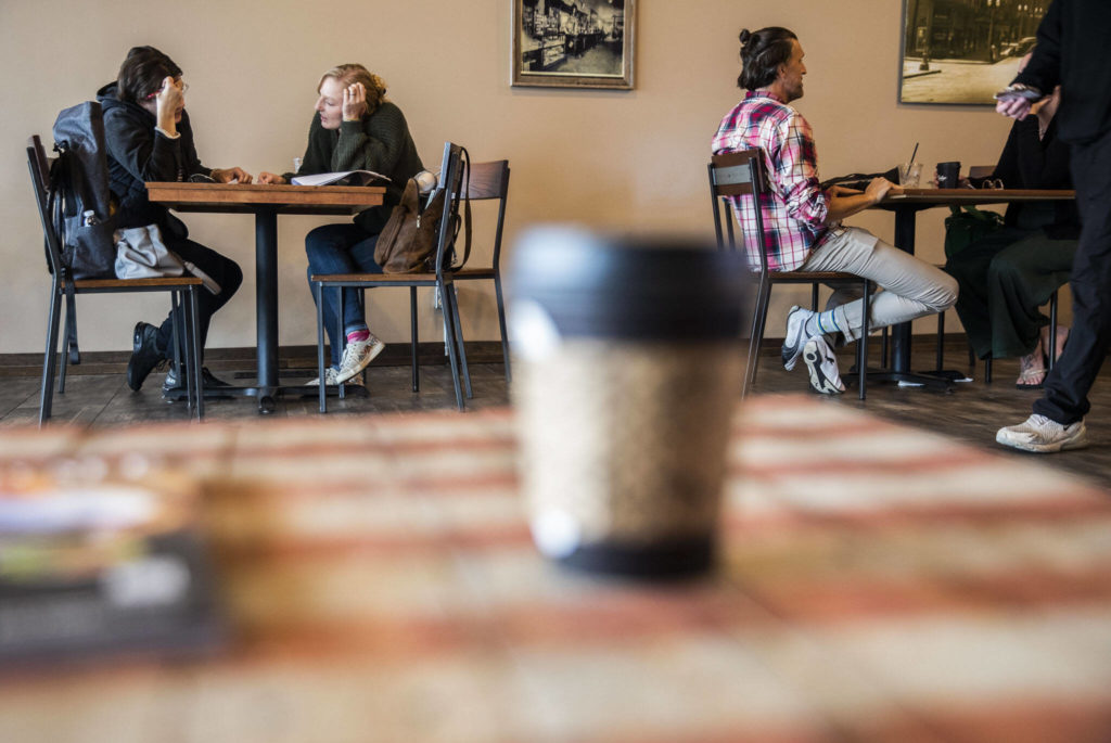 Customers sit at tables at The Loft Coffee Bar on Thursday, in Everett. (Olivia Vanni / The Herald)
