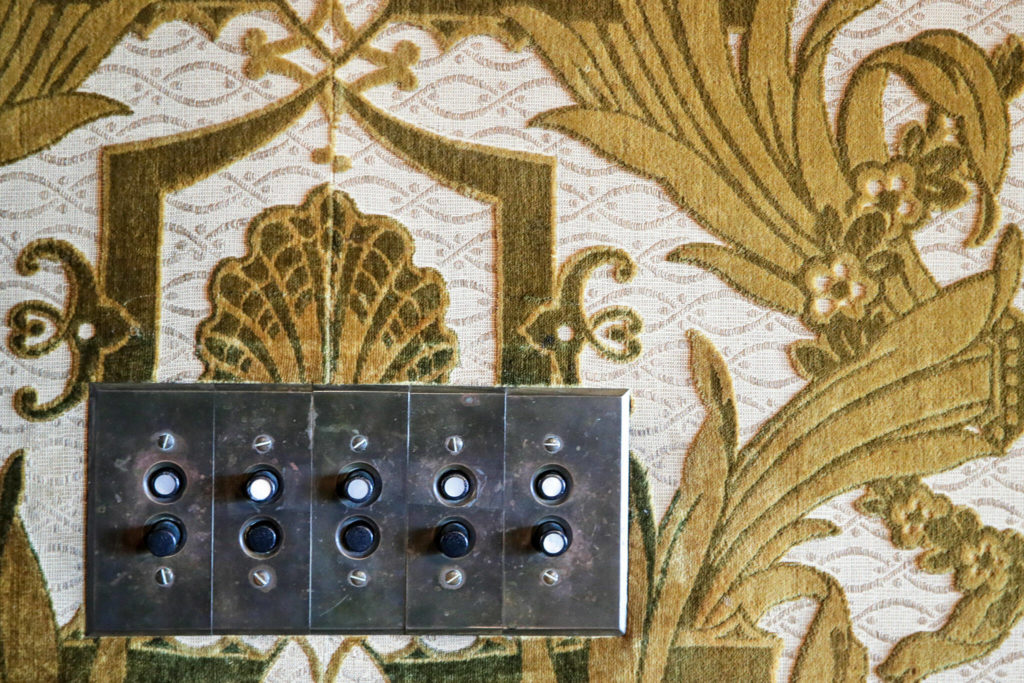 Push button light switch surrounded by velvet wall coverings at the Rucker Mansion on Oct. 11 in Everett. (Kevin Clark / The Herald)

