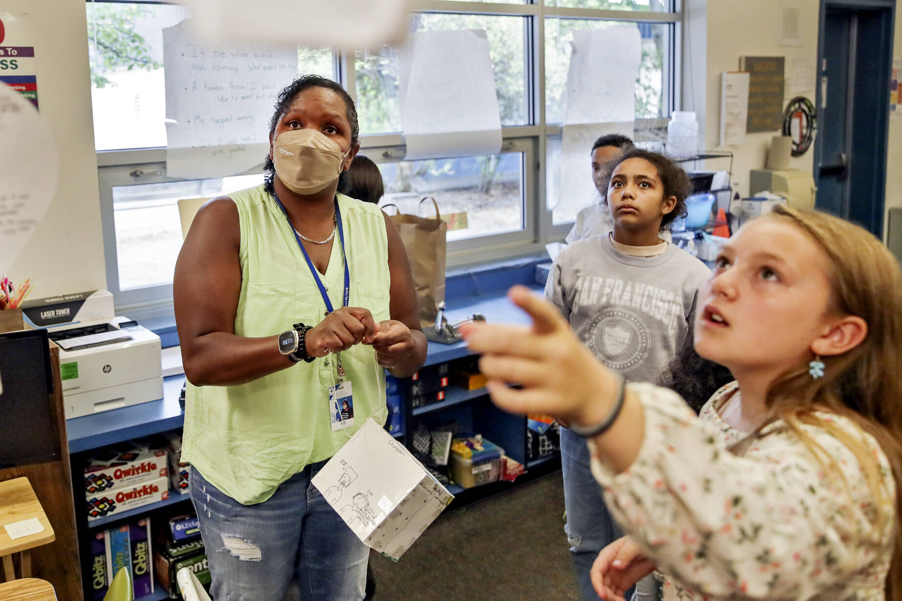 Tanya King, left, looks to where Hailey Newton, right, ask to hang her project on Sept. 14 at Beverly Elementary, in Lynnwood. (Kevin Clark / The Herald)