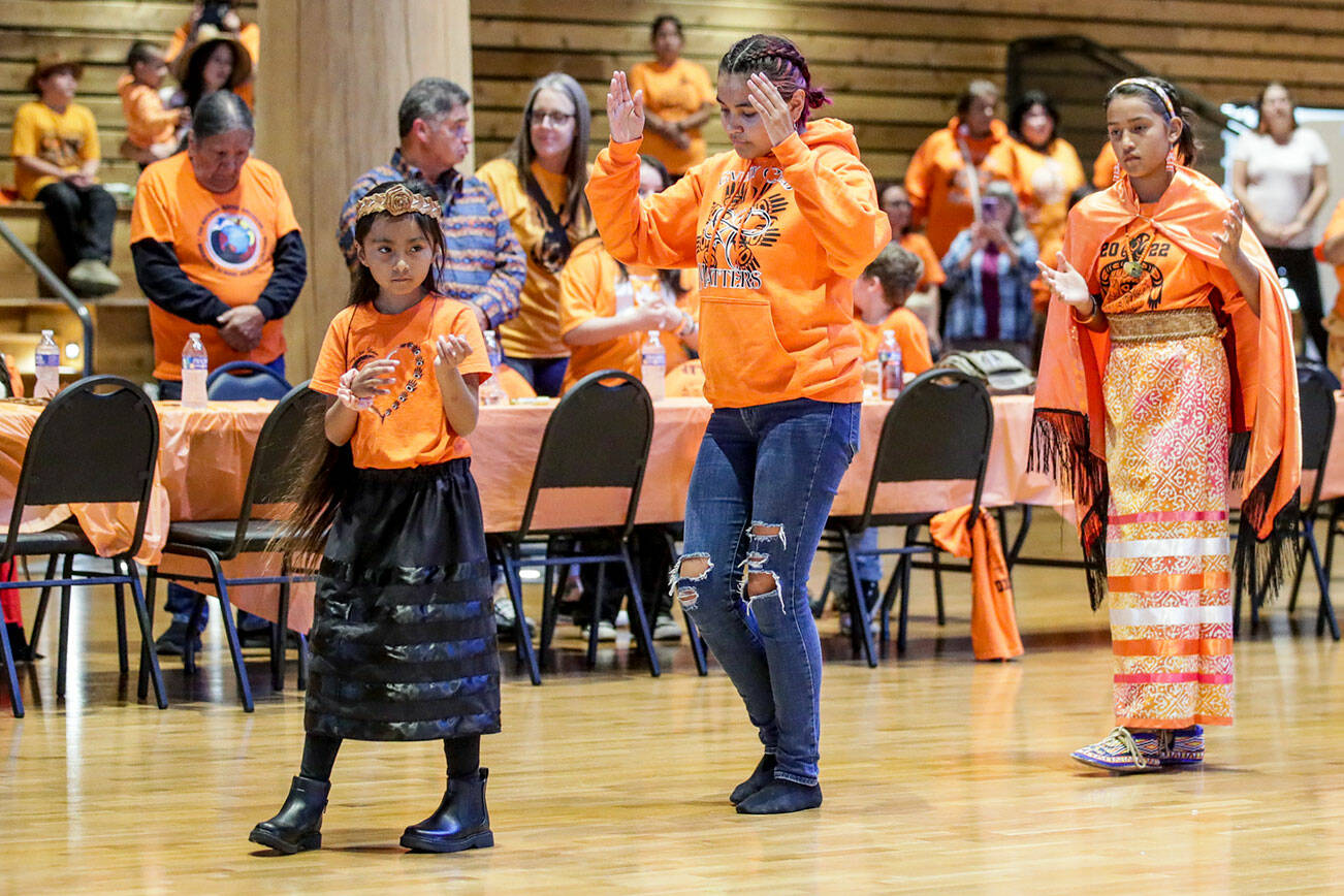 Tribal members dance to start an assemble on the National Day for Truth and Reconciliation and Orange Shirt Day Friday evening at Tulalip Gathering Hall in Tulalip, Washington on September 30, 2022.  (Kevin Clark / The Herald)