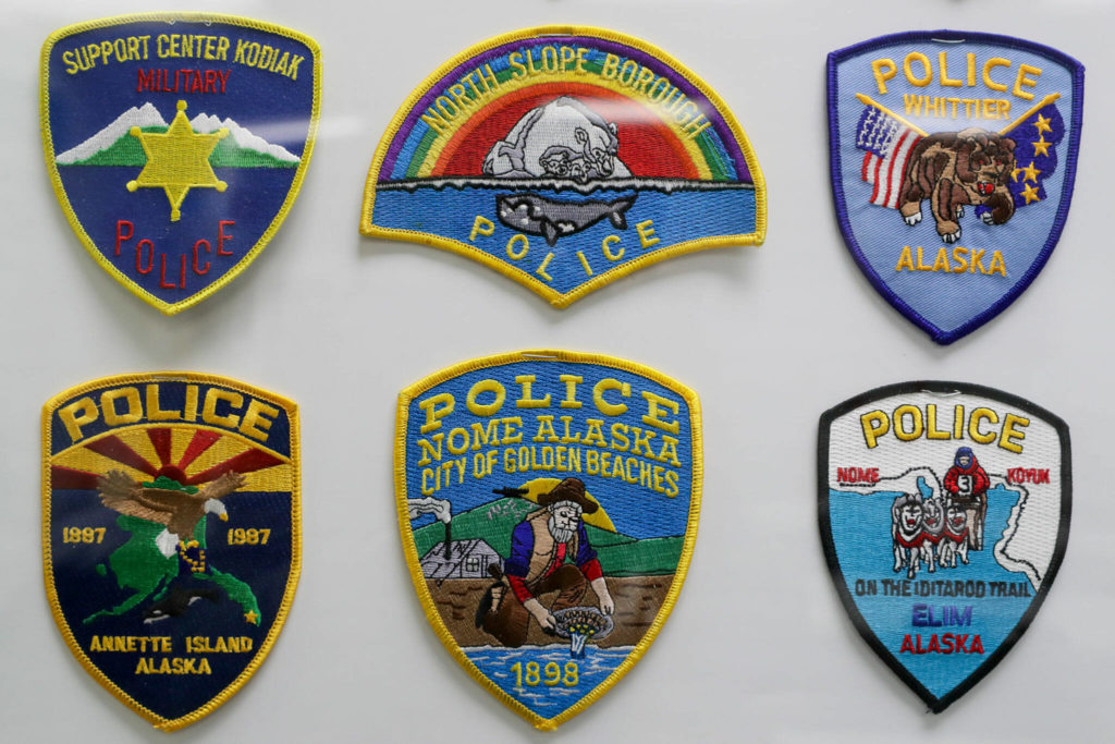A portion of the law enforcement patch collections on display at Everett 911 Driving School, in Everett. (Kevin Clark / The Herald)
