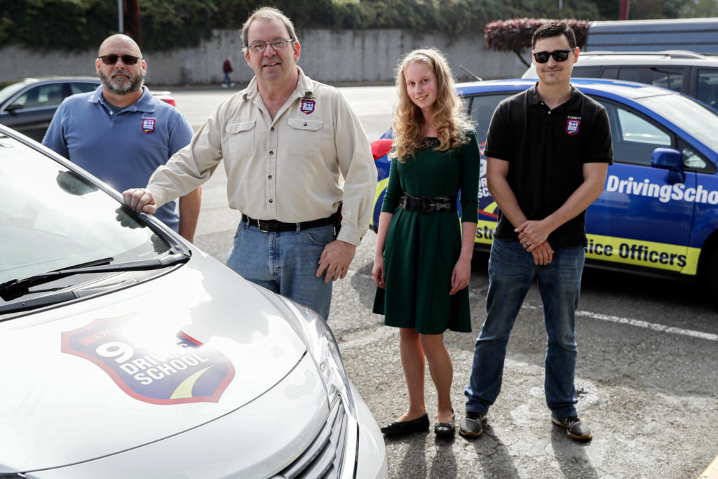 Jeremy Haines, Frank McCahill, Elina Rodin and Barrett Horn of Everett 911 Driving School on Sept. 29, in Everett. (Kevin Clark / The Herald) 
