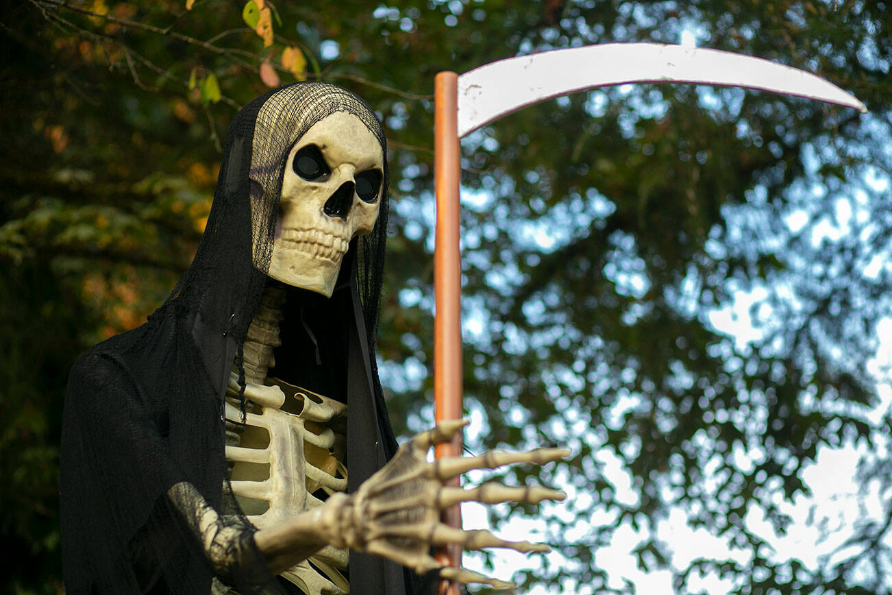 Mr. Bone Jangles holds his scythe Monday, Oct. 17, 2022, in Lake Stevens, Washington. (Ryan Berry / The Herald)