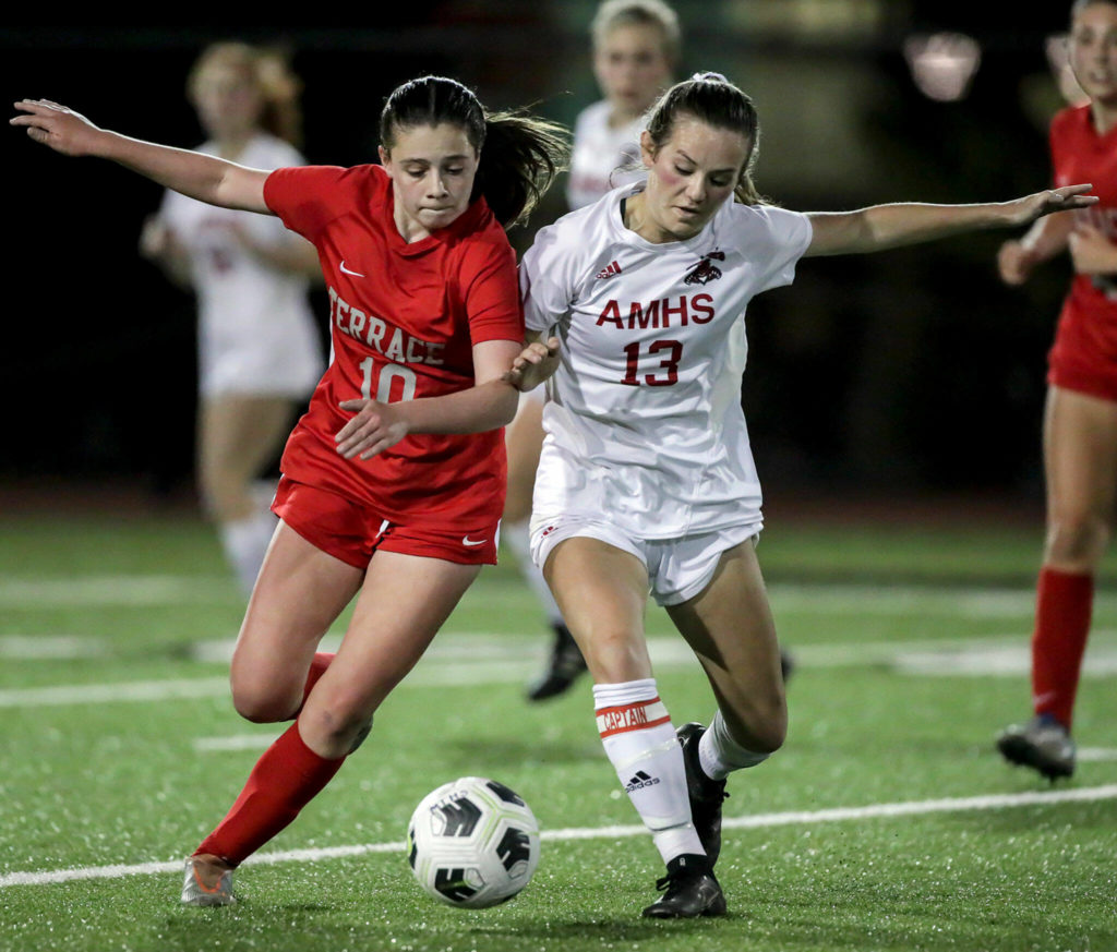 Mountlake Terrace’s Ally Villalobos Van Slooten, left, and Archbishop Murphy’s Cameron Bourne race to control the ball Sept. 22 at Lynnwood High School in Bothell. (Kevin Clark / The Herald)
