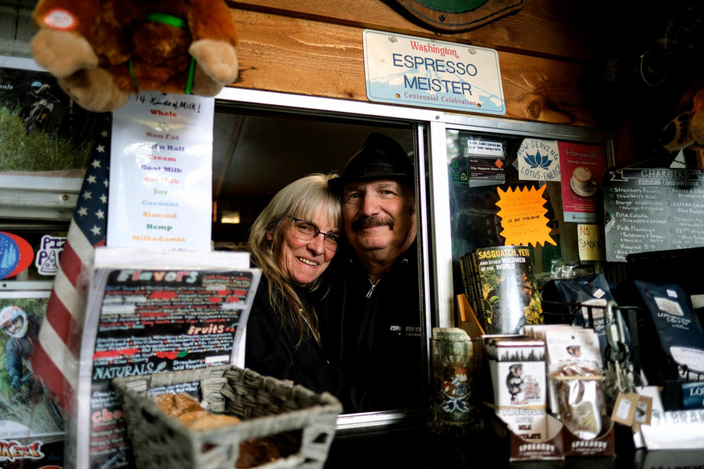 Espresso Chalet owners Sandy and Mark Klein pose in their tiny coffee shop of 31 years, on Sept. 27. They converted the space from a camper. (Taylor Goebel / The Herald)
